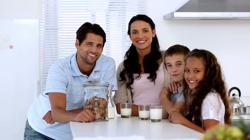 a photo of a Pat and his family with milk and cookies